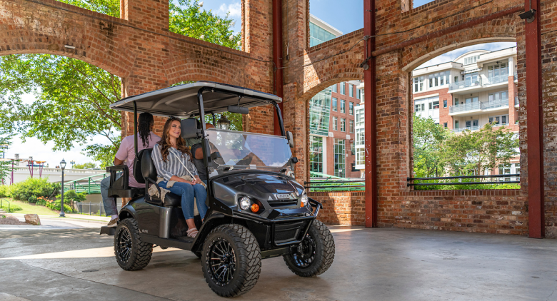 People driving golf cart